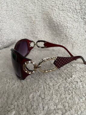 Italian design red purple color sunglasses in good condition with light scratche
